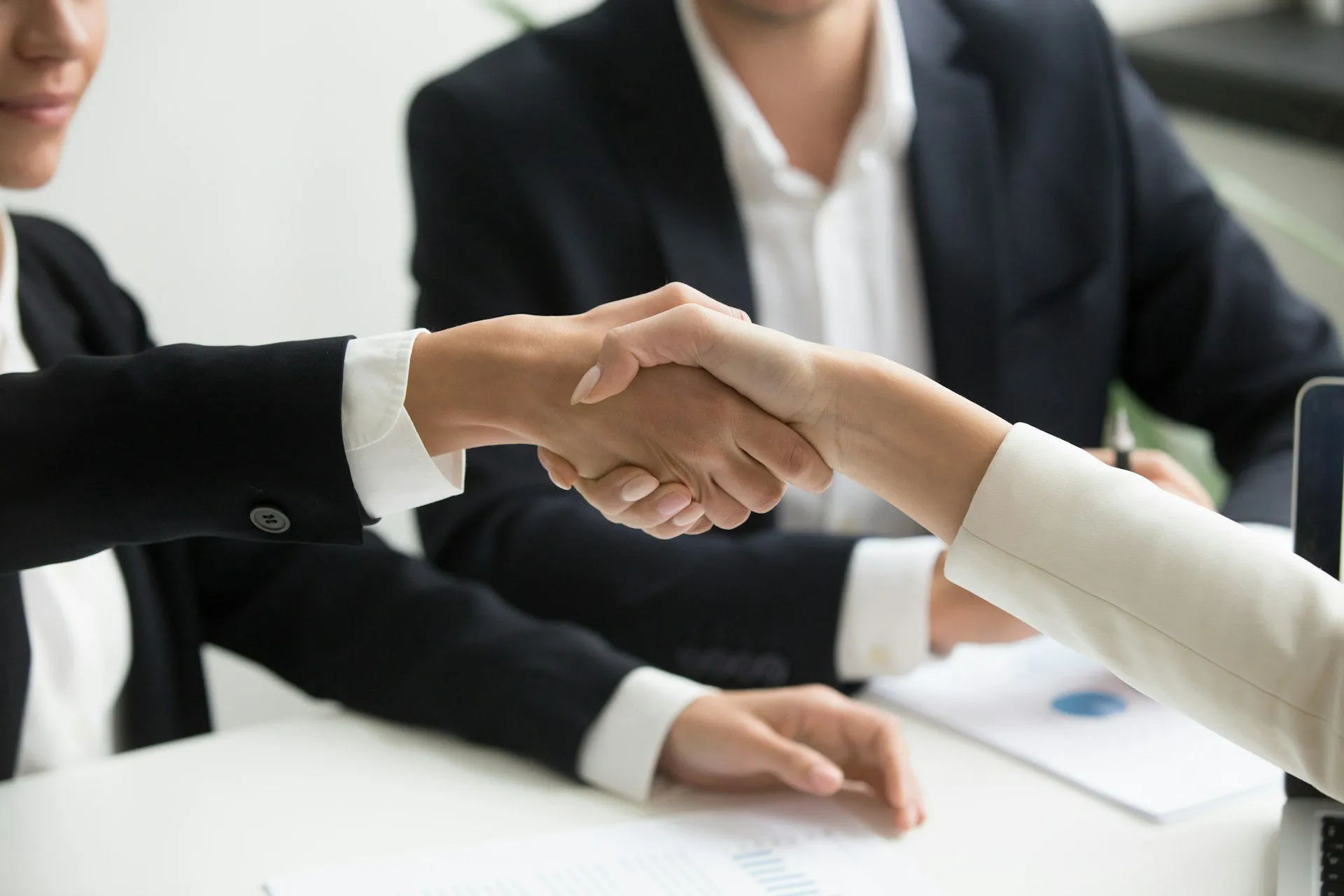A handshake between two business woman.